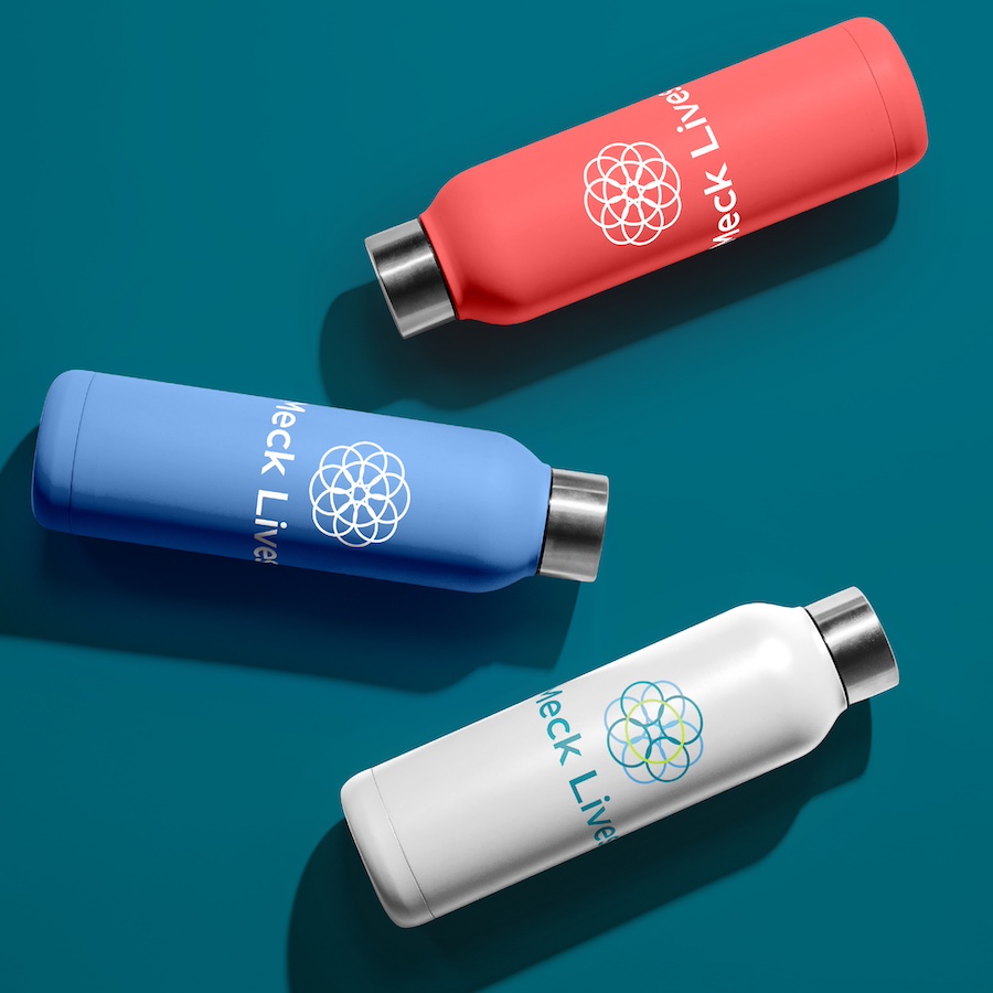 An image of a mockup of pink, blue, and white water bottles each displaying the Meck Lives logo and name